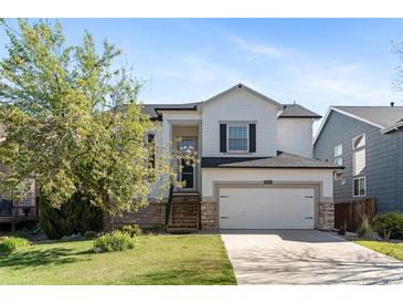 Charming two-story home featuring a well-manicured lawn and a two-car garage at 8864 S Field Ct, Littleton, CO 80128