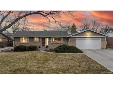 Charming single-story home with brick accents, attached garage, and a well-maintained front yard at 1823 S Carr St, Lakewood, CO 80232