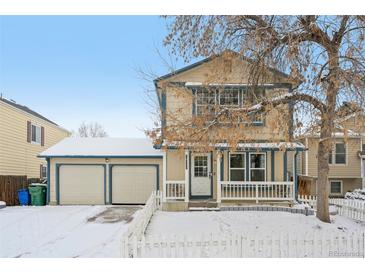 Two-story house with attached garage and picket fence, snow on the ground at 18737 E Carmel Cir, Aurora, CO 80011