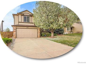 Charming two-story home featuring an attached two-car garage, and a well-manicured lawn at 6343 Laguna Cir, Highlands Ranch, CO 80130