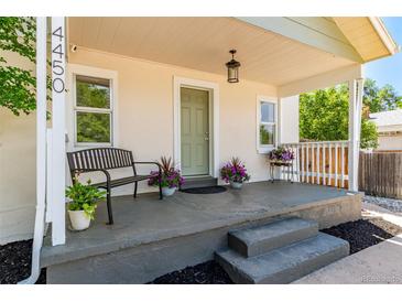Inviting front porch with bench seating and decorative plants, perfect for enjoying the outdoors at 4450 S Fox St, Englewood, CO 80110