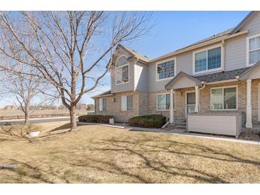 Charming two-story townhouse featuring a brick facade and well-maintained front yard at 1283 W 112Th Ave # B, Denver, CO 80234