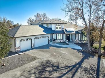 Two-story house with three-car garage and landscaped yard at 16521 E Easter Way, Foxfield, CO 80016