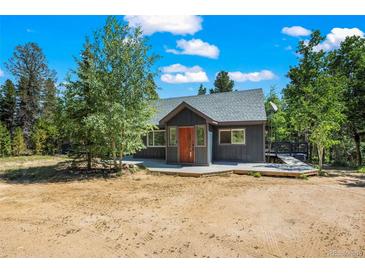 Charming exterior view of the home with a wooden deck and natural surroundings at 10411 Dowdle Dr, Golden, CO 80403