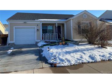 Charming single Gathering home featuring a front porch and attached one car garage during winter at 15614 E 51St Pl, Denver, CO 80239