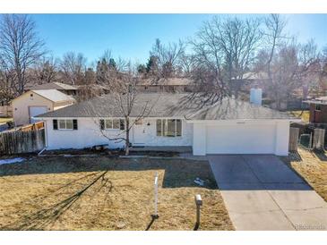 Charming one-story home with freshly painted exterior, well-maintained lawn, and attached garage at 10930 W Tulane Ave, Littleton, CO 80127