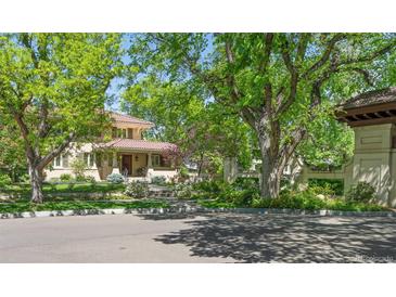 Charming home exterior with lush landscaping, mature trees, and a red-tiled roof at 395 N Franklin St, Denver, CO 80218