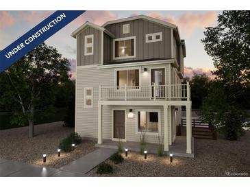 Two-story home with light-colored siding, multiple windows, and a balcony at 13518 E 103Rd Pl, Commerce City, CO 80022
