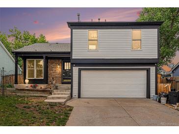 Two-story home featuring a garage and front yard at 11407 W 103Rd Ave, Broomfield, CO 80021