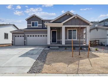Charming two-story home with a three-car garage, neutral paint, and manicured front yard at 14378 Heritage Dr, Mead, CO 80504