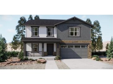 Charming two-story home featuring a welcoming front porch and a two-car garage at 21965 E 39Th Ave, Aurora, CO 80019