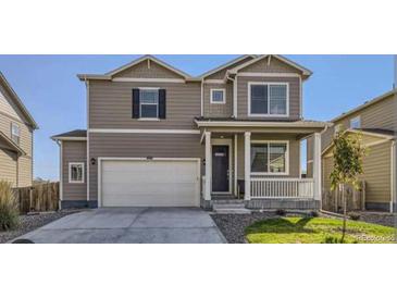 Two-story house with a large garage and well-maintained lawn at 2300 Mountain Sky Dr, Fort Lupton, CO 80621