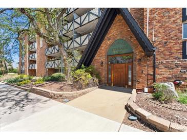 Inviting Dublin Terrace entrance featuring a brick facade, a garden area, and well-maintained landscaping at 1350 Josephine St # 307, Denver, CO 80206