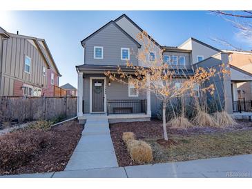 Charming two-story home featuring neutral siding, landscaped yard, and welcoming front porch at 11440 E 26Th Ave, Aurora, CO 80010