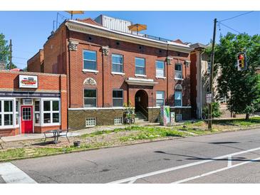 Charming brick building featuring architectural details, a rooftop terrace, and street-level access to local businesses at 2524 Champa St # 4, Denver, CO 80205