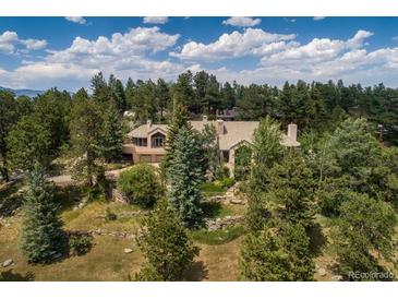 Secluded property surrounded by trees with stone retaining walls, offering privacy and a natural setting at 1682 Montane E Dr, Golden, CO 80401