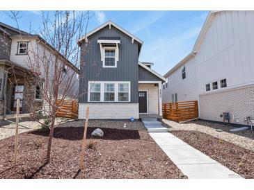 Charming two-story home featuring vertical siding, a stone accent wall, and a well-manicured front yard at 23920 E 34Th Ave, Aurora, CO 80019