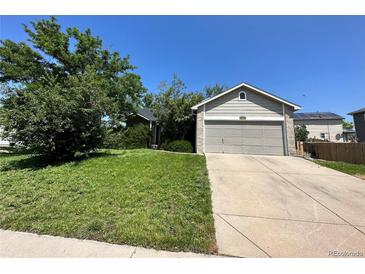 Ranch style home with attached garage and landscaped yard at 4759 S Flanders St, Centennial, CO 80015