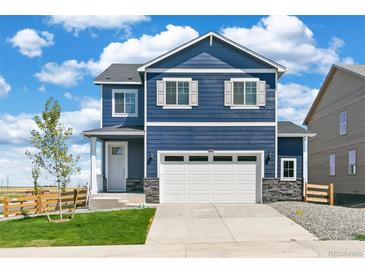 Charming two-story home featuring blue siding, white trim, and a well-manicured front lawn at 17959 Dandy Brush Ln, Parker, CO 80134
