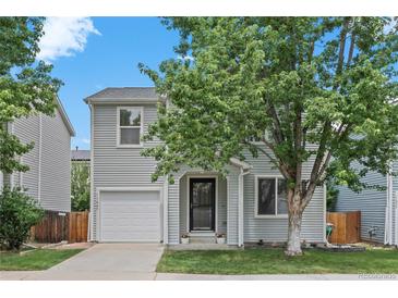 Charming two-story home with a well-manicured front yard, and a one car garage at 11845 W Tulane Dr, Morrison, CO 80465