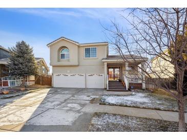 Two-story house with a large driveway and attached two-car garage at 4806 Jericho Ct, Denver, CO 80249