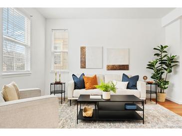 Inviting living room featuring modern decor, stylish furnishings, and ample natural light at 3815 Red Deer Trl, Broomfield, CO 80020
