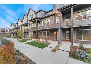 Charming multi-story townhomes feature brick and modern gray siding, plus small front lawns for a suburban feel at 5165 Vivian St, Wheat Ridge, CO 80033