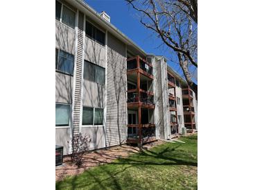 Multi-story condo building with private wood balconies and neutral siding at 8657 Clay St # 383, Westminster, CO 80031