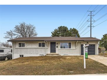 Charming single-story home with a brick facade and well-maintained front yard at 8097 E Lehigh Dr, Denver, CO 80237
