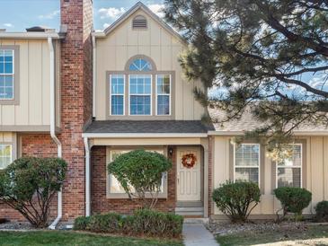 Brick front elevation of charming townhome with landscaping at 9618 W Chatfield Ave # E, Littleton, CO 80128