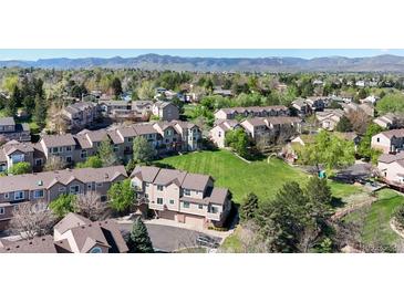 Scenic aerial view of townhomes with lush green spaces and mountain views in the distance at 6809 S Webster St # F, Littleton, CO 80128