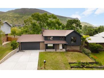 Inviting two-story home with a dark paint scheme, brick accents and a well-maintained lawn at 1029 N Columbine St, Golden, CO 80403
