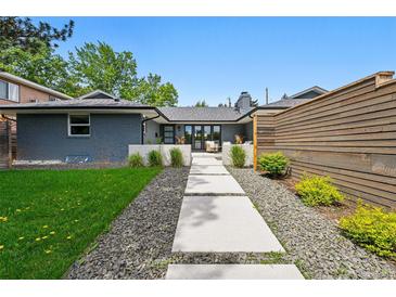 Charming single-story home featuring a well-maintained lawn, stepping stone walkway, and beautifully landscaped front yard at 3275 19Th St, Boulder, CO 80304