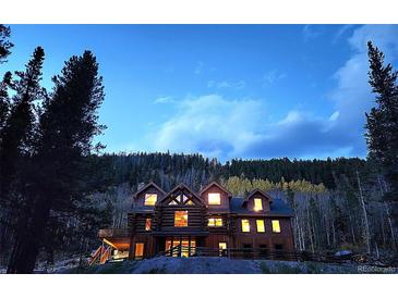 Beautiful log home featuring a serene and peaceful environment among nature at 733 Rainbow Rd, Idaho Springs, CO 80452