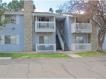 Charming condo with stone chimney, dual balconies, and well-maintained landscaping at 13494 E Jewell Ave # 201, Aurora, CO 80012