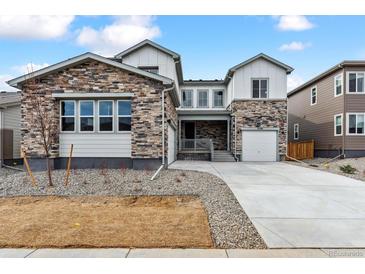 Beautiful home with stone accents, a well-manicured lawn, and a modern driveway at 2536 Wesley Ln, Lafayette, CO 80026