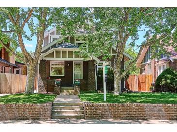 Charming brick home with well-manicured lawn and mature trees offering shade and curb appeal at 2683 Bellaire St, Denver, CO 80207