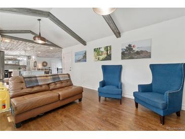 Bright living room features hardwood floors, beamed ceilings and stylish furnishings at 11542 W 67Th Way, Arvada, CO 80004