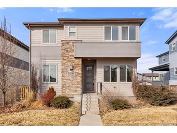 Contemporary two-story home with stone accents, manicured landscaping, and a welcoming front entrance at 9628 Dunning Cir, Highlands Ranch, CO 80126