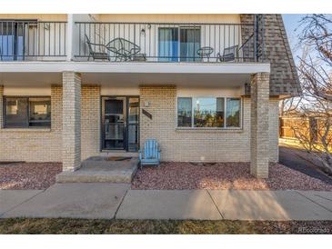 Charming condo facade with a brick exterior, balcony, and lovely curb appeal at 11455 W 17Th Pl, Lakewood, CO 80215
