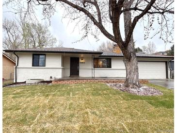 Charming ranch style home with a brick accent wall, new paint, mature landscaping and a spacious two car garage at 10253 W 68Th Way, Arvada, CO 80004