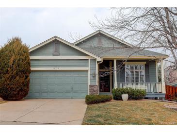 Charming single-Gathering home featuring a well-manicured front yard and an attached two-car garage at 16159 W 70Th Pl, Arvada, CO 80007