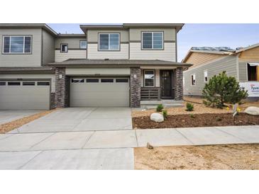 Charming two-story home with a concrete driveway, neutral siding, and a well-manicured front yard at 6616 N Nepal St, Aurora, CO 80019