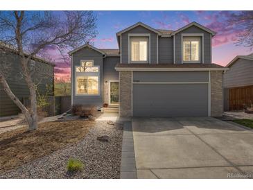 Charming two-story home with a well-manicured lawn and inviting curb appeal at 3166 W Indian Summer Ln, Castle Rock, CO 80109