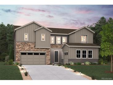 Charming two-story home featuring stone accents, gray siding and a two-car garage at 13770 Emerald Lake St, Parker, CO 80138