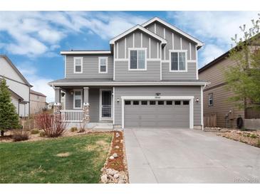 Charming gray two-story home with a well-manicured lawn and attached two-car garage at 7844 Grady Cir, Castle Rock, CO 80108