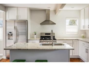 Bright kitchen with granite countertops, stainless steel appliances, and a large island at 190 S Canosa Ct, Denver, CO 80219