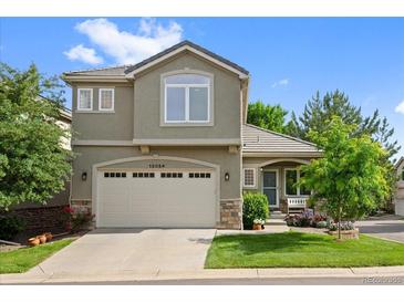 Charming two-story home boasts a manicured front lawn, two-car garage, and inviting curb appeal at 12054 E Lake Cir, Greenwood Village, CO 80111