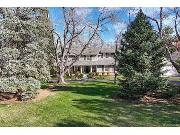 Charming two-story home featuring a landscaped yard and inviting front porch, perfect for enjoying the outdoors at 4 Brookside Dr, Greenwood Village, CO 80121