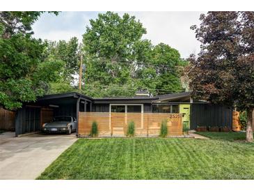 Charming single-story home with a modern design, landscaped front yard, and a covered carport at 2525 S Meade St, Denver, CO 80219